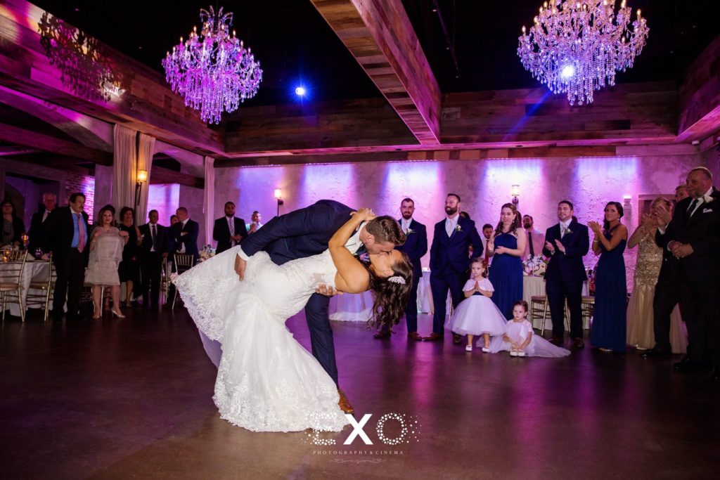 Groom dipping the bride during their wedding dance at The Loft at Bridgeview Yacht Club