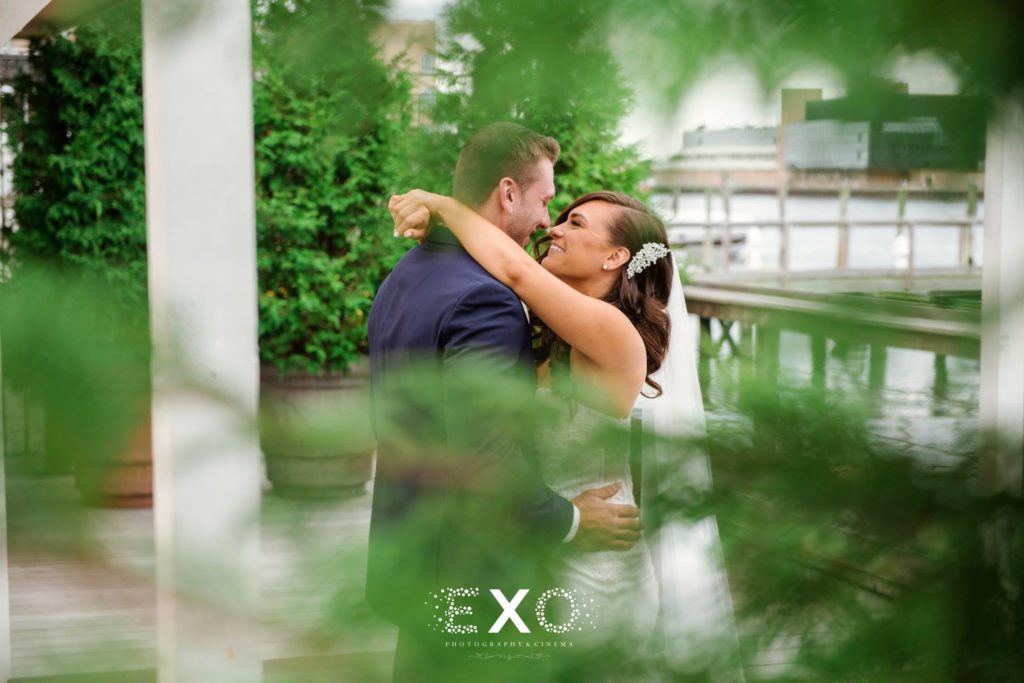 Bride and groom kissing outside The Loft at Bridgeview Yacht Club