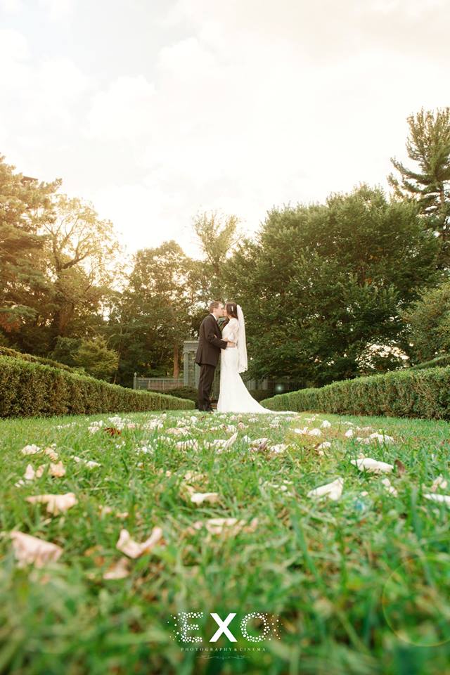 bride and groom kissing in the garden at North Shore Country Club