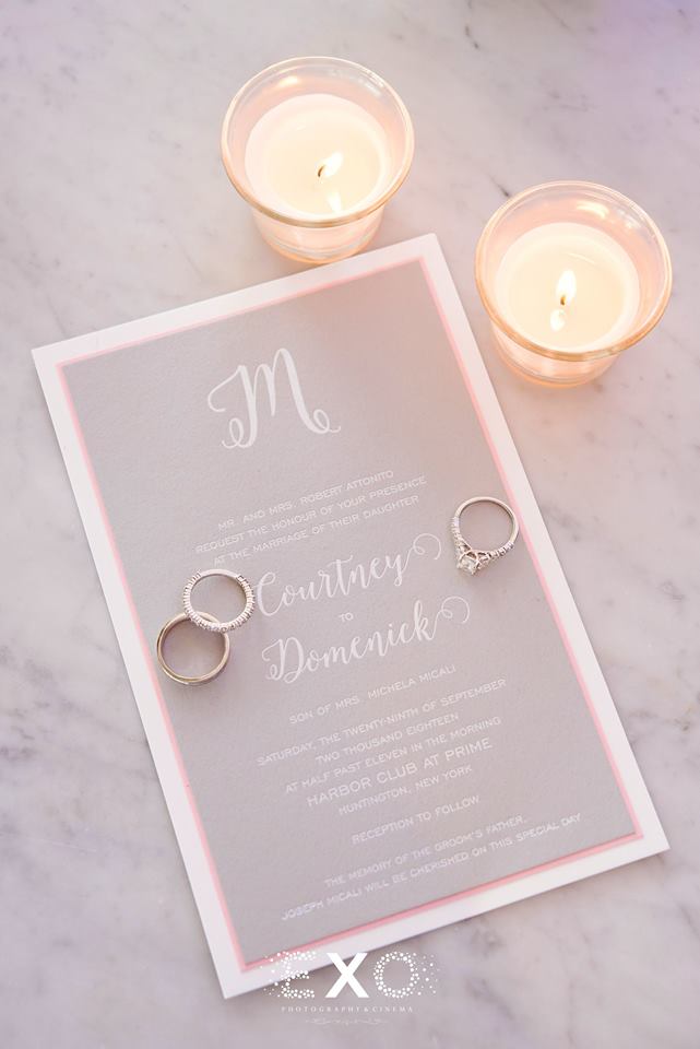 wedding invitation with wedding bands and candles