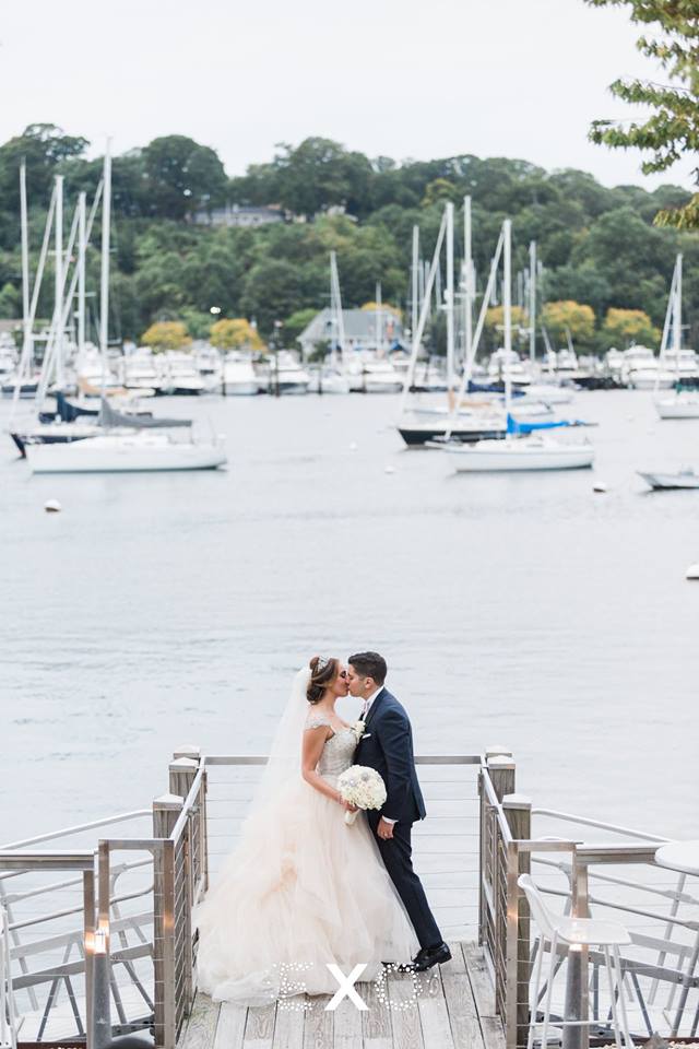 bride and groom kissing on the dock at Harbor Club at Prime