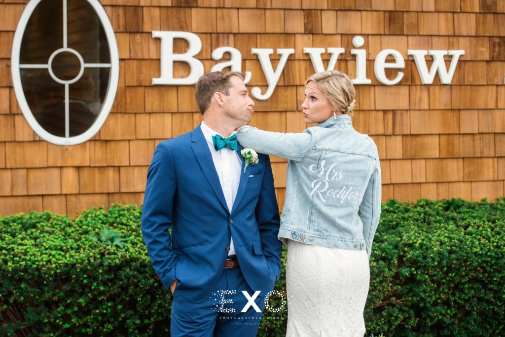 bride and groom posing in front of bayview house