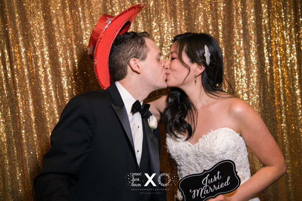 bride and groom kissing in photo booth at North Shore Country Club