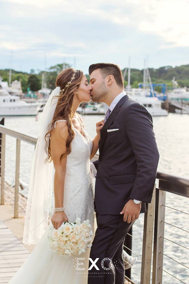 bride and groom kissing on the deck
