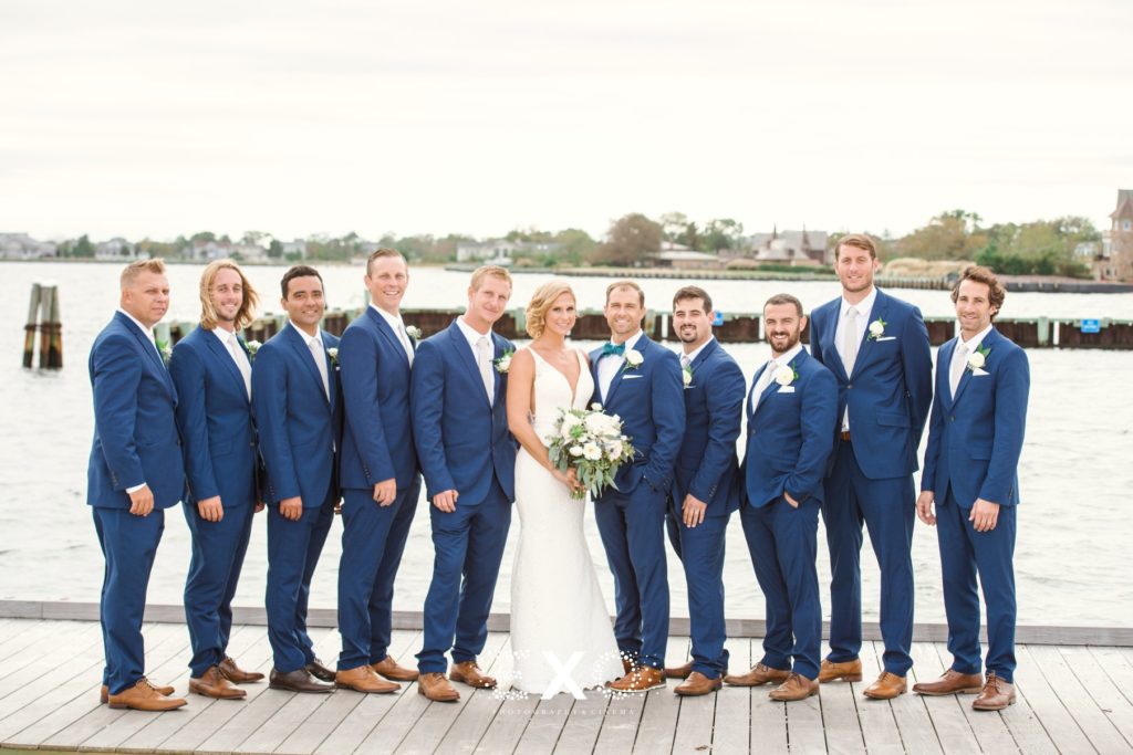 bride and groom with groomsmen on the dock at Captain Bills