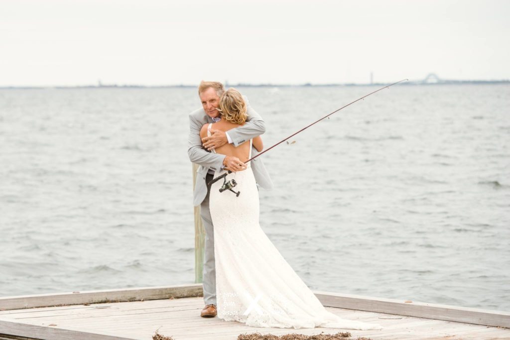 bride and her father hugging on the dock at Captain Bills