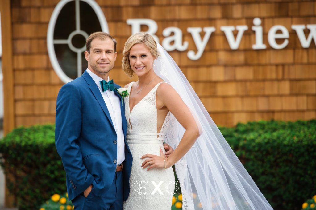 bride and groom posing outside bayview house at Captain Bills