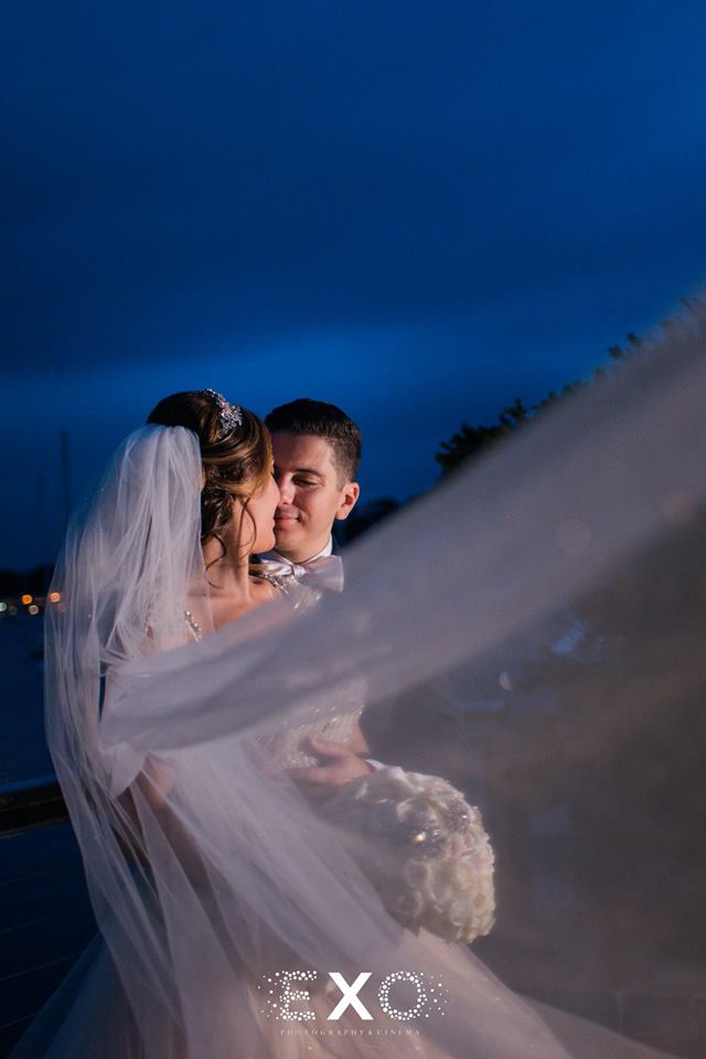 bride and groom with bride's veil blowing at Harbor Club at Prime