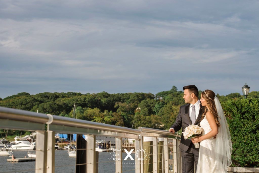 bride and groom looking out over the water at Harbor Club at Prime