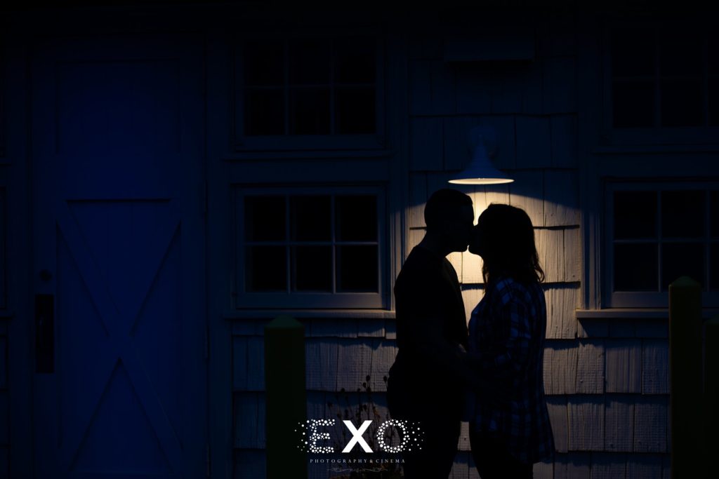 Couple kissing in the dark under a lamp