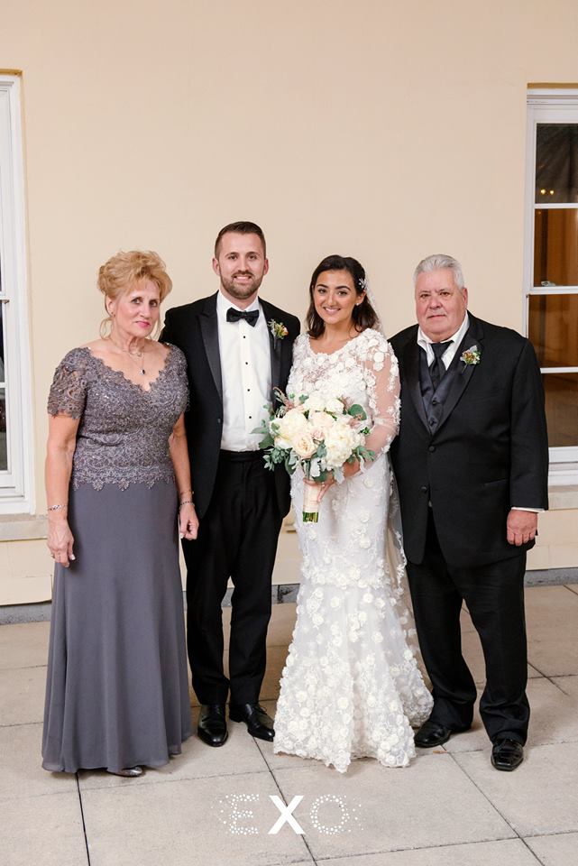 bride and groom with parents at The Mansion at Oyster Bay