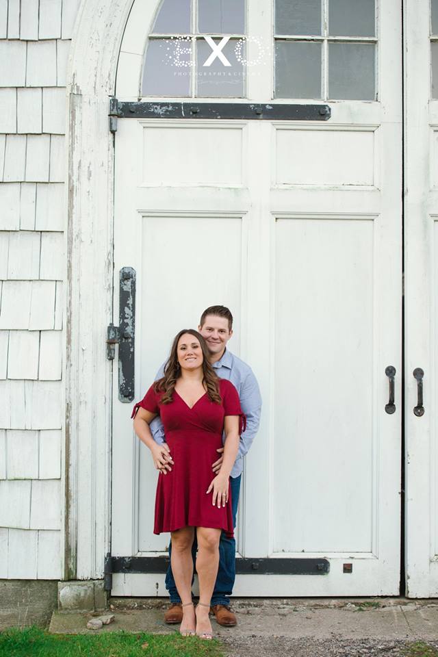 couple standing in front of rustic building at Caumsett State Park