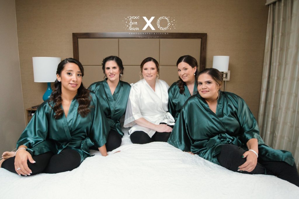 bride and bridesmaids on bed at Willow Creek Golf and Country Club