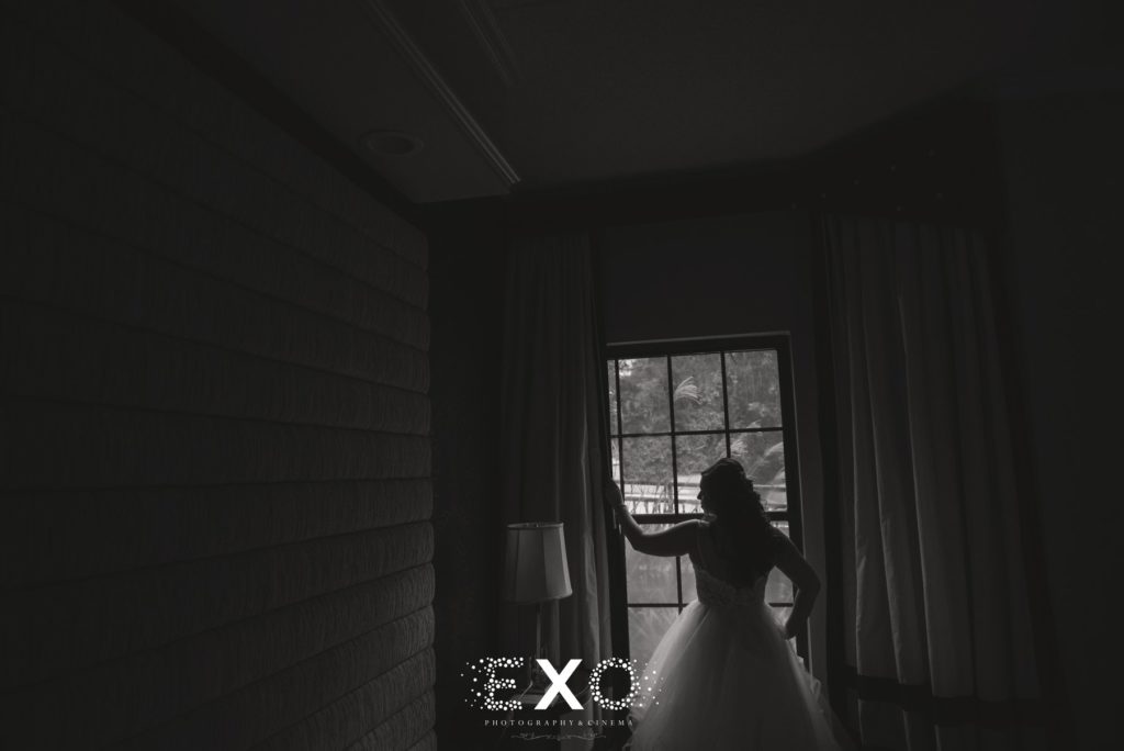 Bride looking outside the window at Fox Hollow