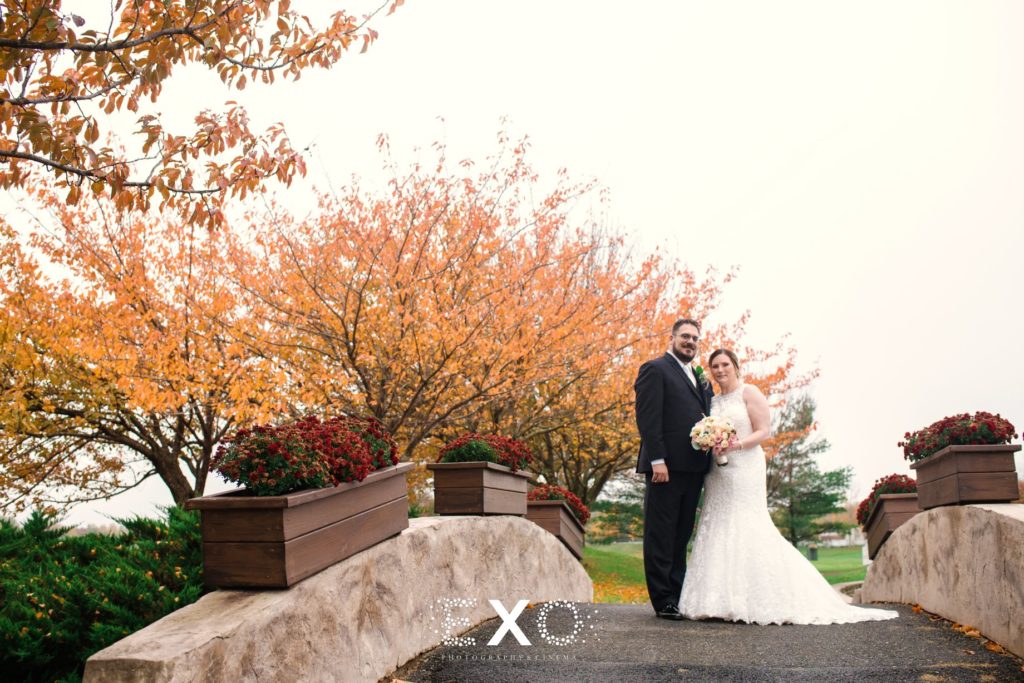 bride and groom on bridge at Willow Creek Golf and Country Club