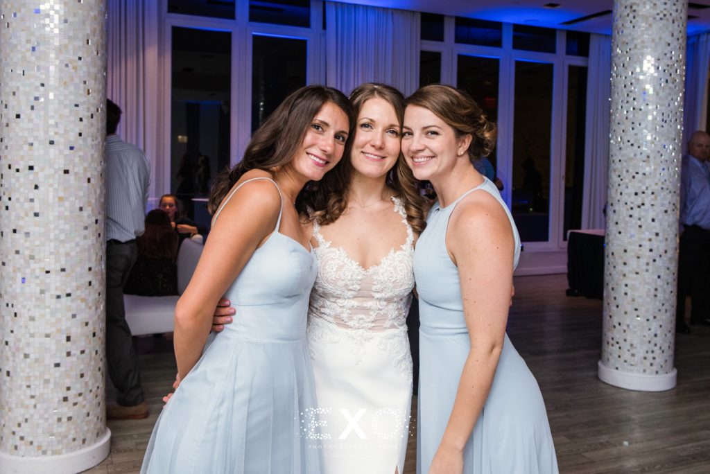 bride and bridesmaids smiling on the dance floor at Allegria Hotel