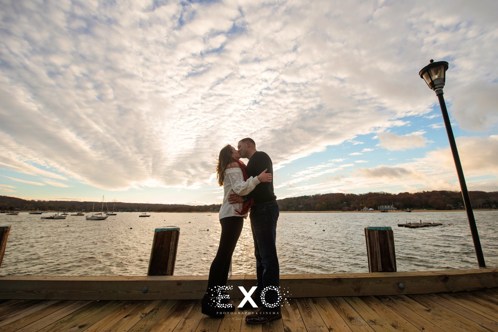 Couple kissing on the dock in Northport Village