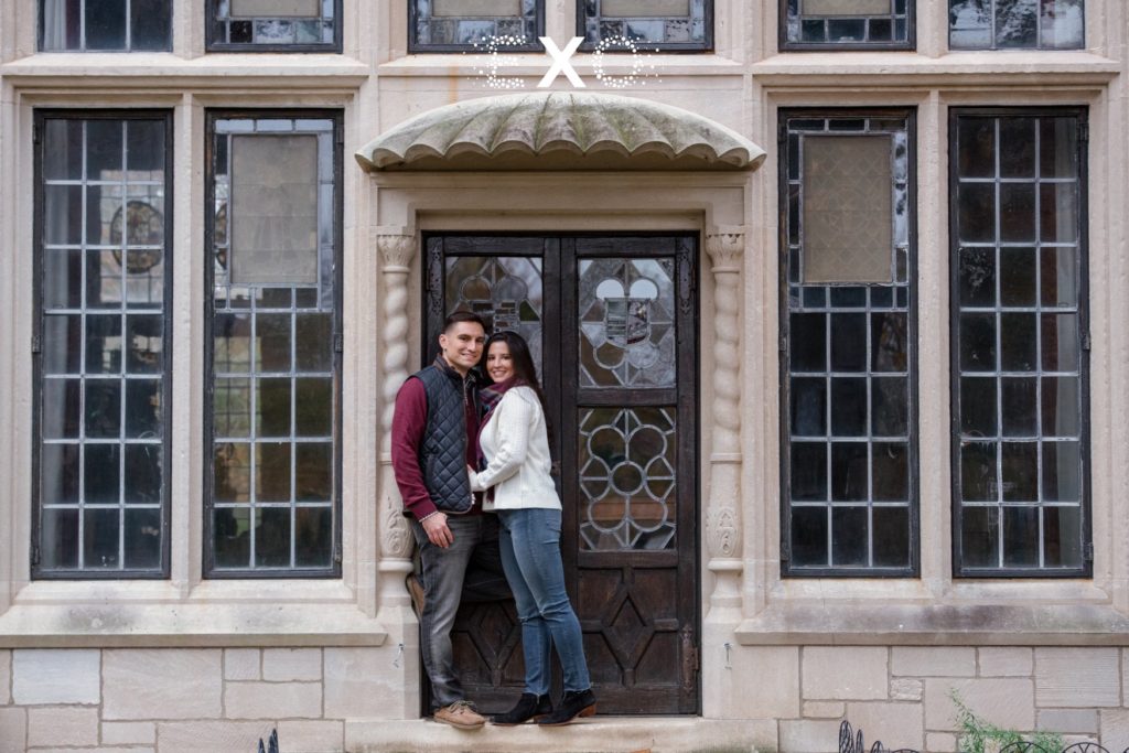 couple posing against the building