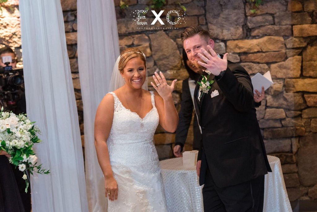 Bride and groom with wedding bands on at Fox Hollow