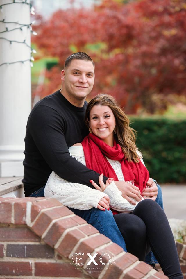 Couple posing on steps in Northport Village