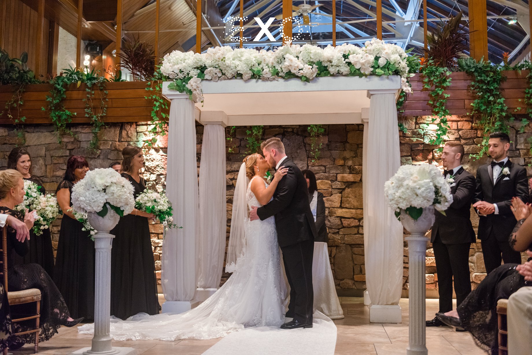 Bride and groom kissing at the altar at Fox Hollow