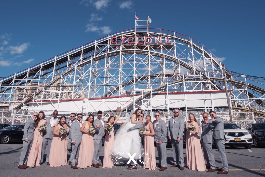 bridal party in front of rollercoaster