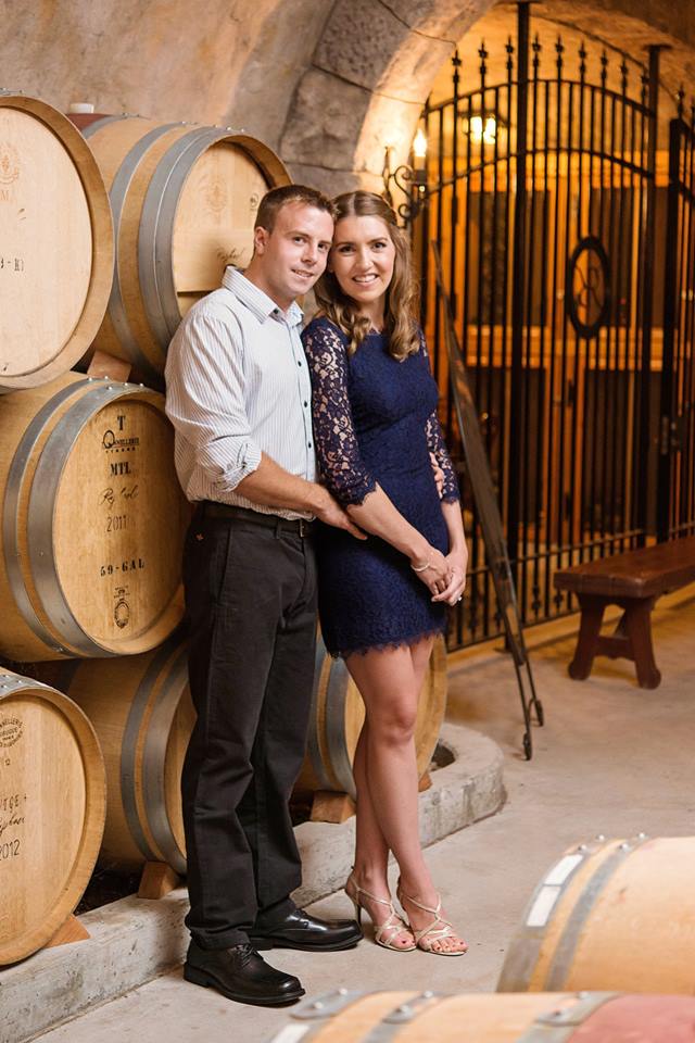 couple posing in wine cellar at Rafael Vineyard