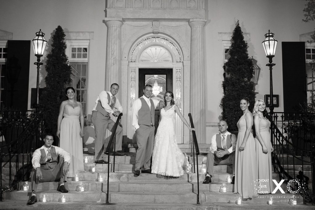 bride and groom with bridal party outside The Mansion at Oyster Bay