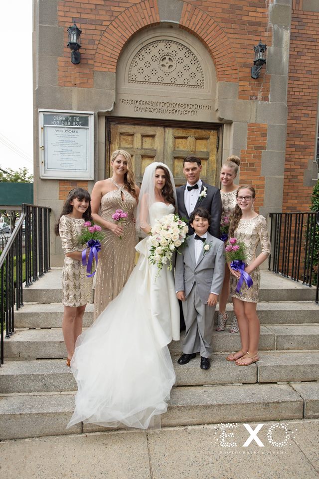 bride and groom with bridesmaids outside church
