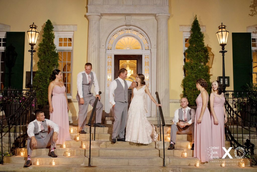 bride and groom with bridal party on steps outside The Mansion at Oyster Bay
