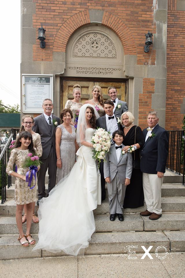 bride and groom with family outside church
