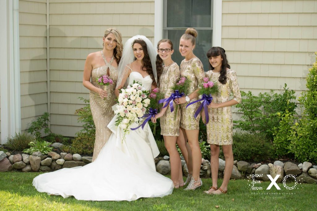 bride and bridesmaids outside her house