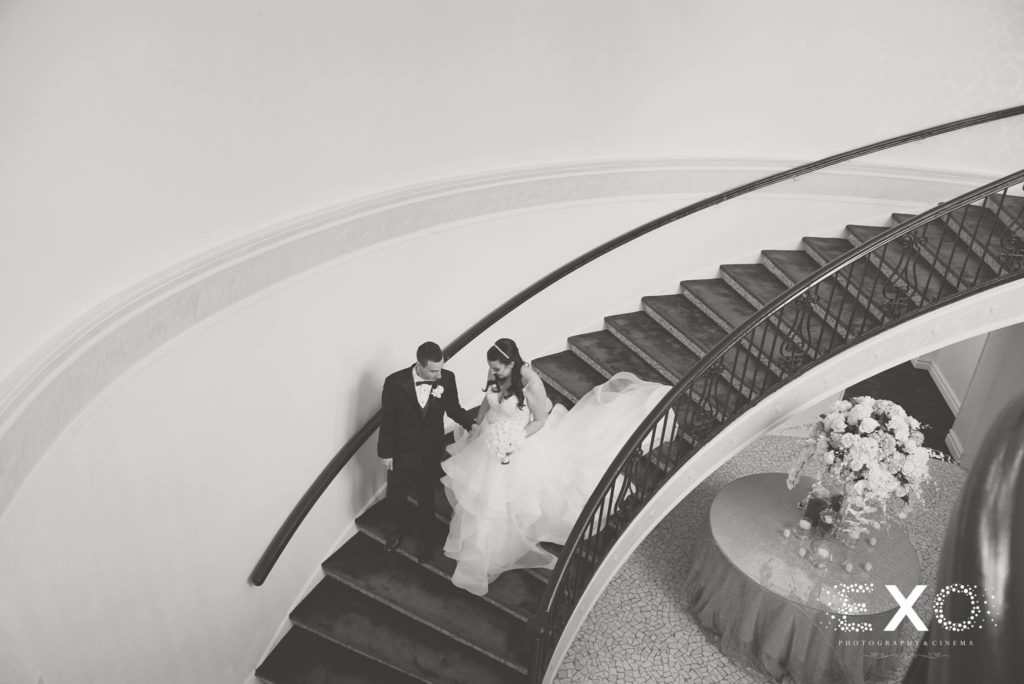 bride and groom walking down the stairs at Temple Beth El Cedarhurst