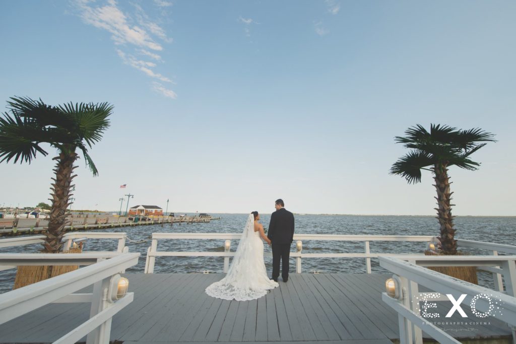 bride and groom looking at one another on the dock at Chateau La Mer