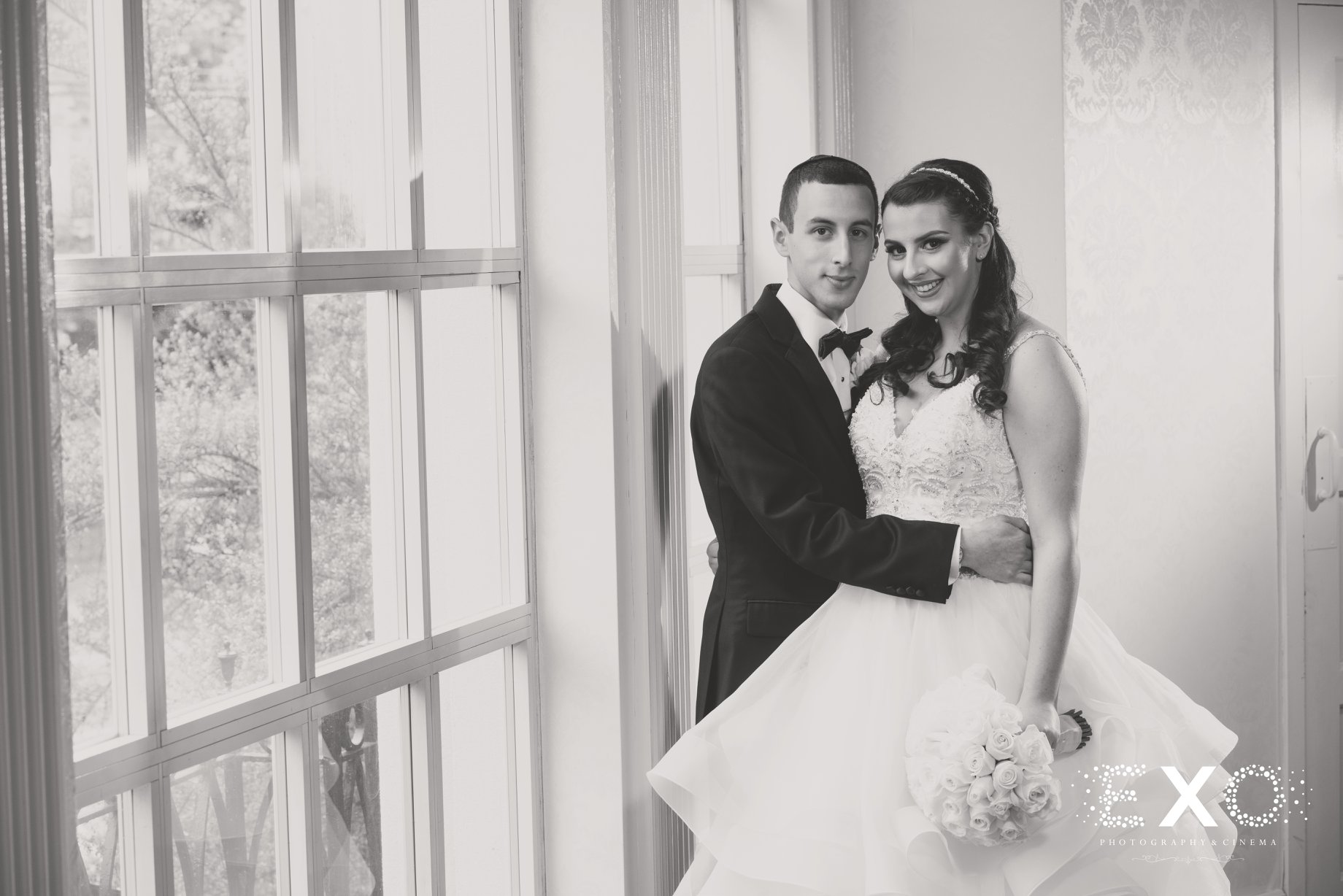bride and groom smiling at Temple Beth El Cedarhurst