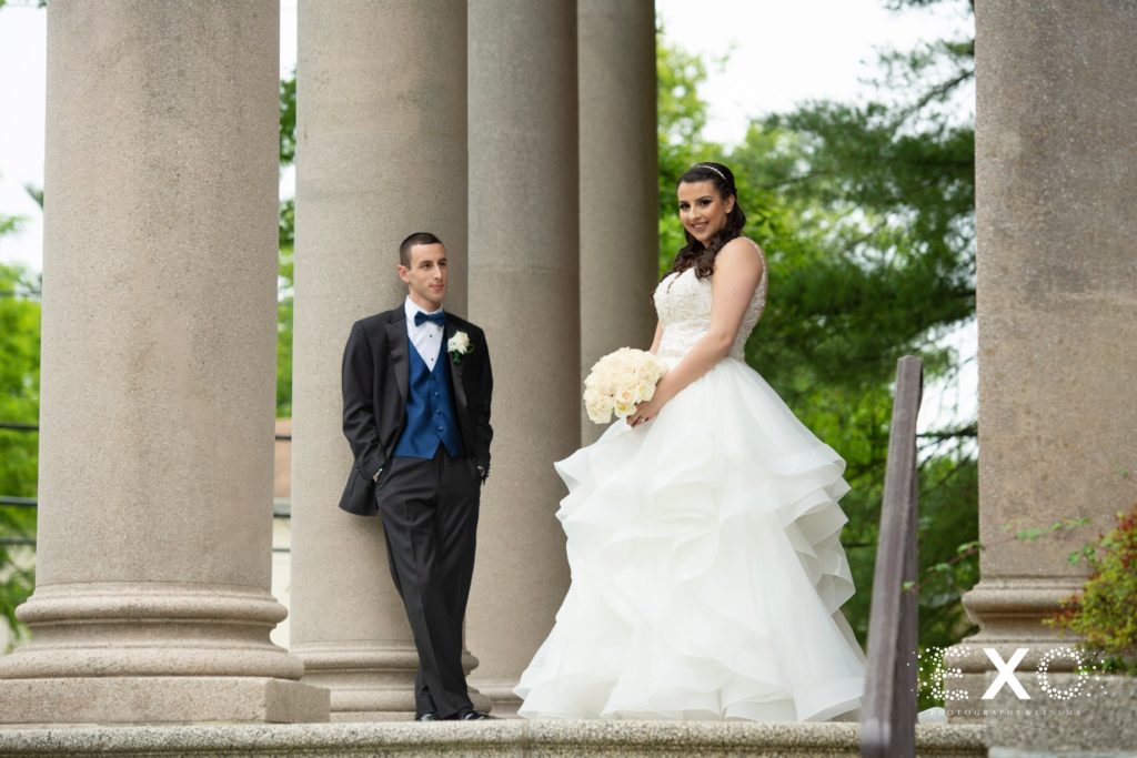 bride and groom posing at Temple Beth El Cedarhurst