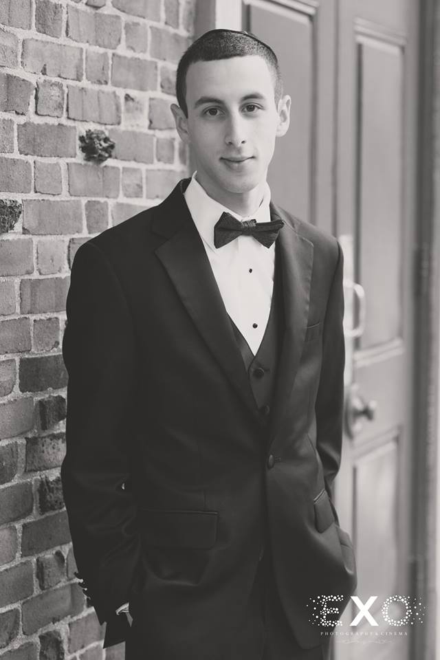 groom posing in black and white