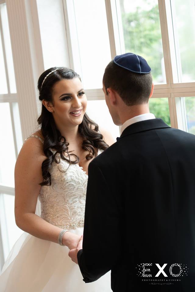 bride and groom looking at each other at Temple Beth El Cedarhurst