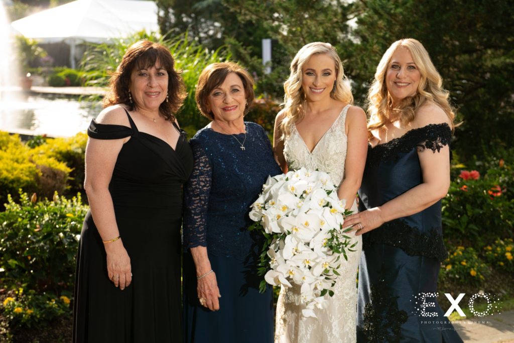 bride with all the women in her family at Woodbury Country Club