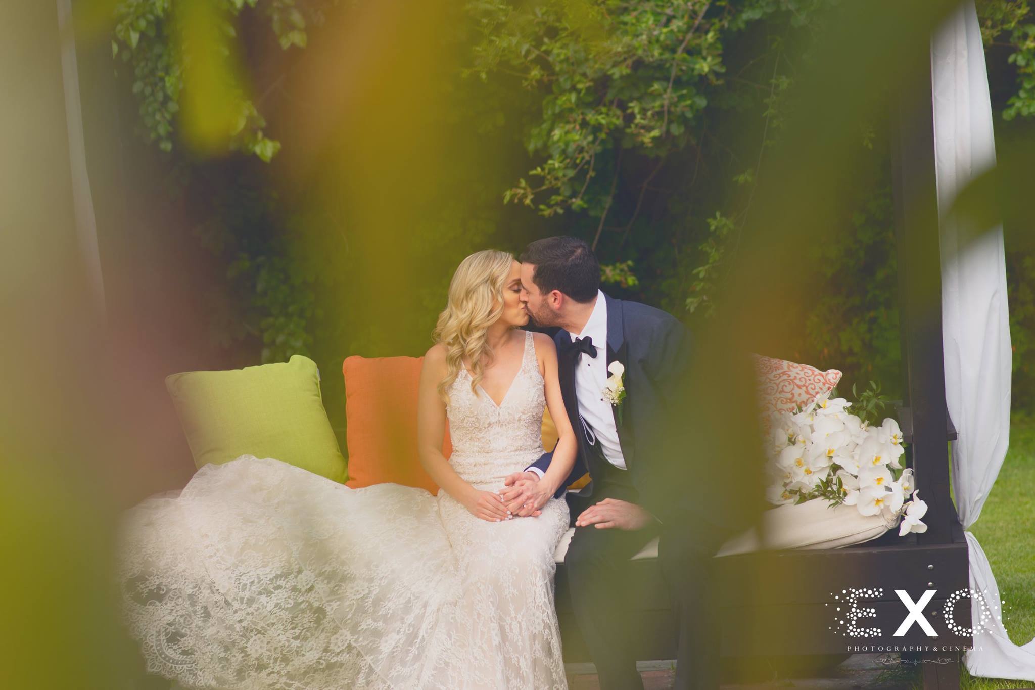bride and groom kissing on the couch