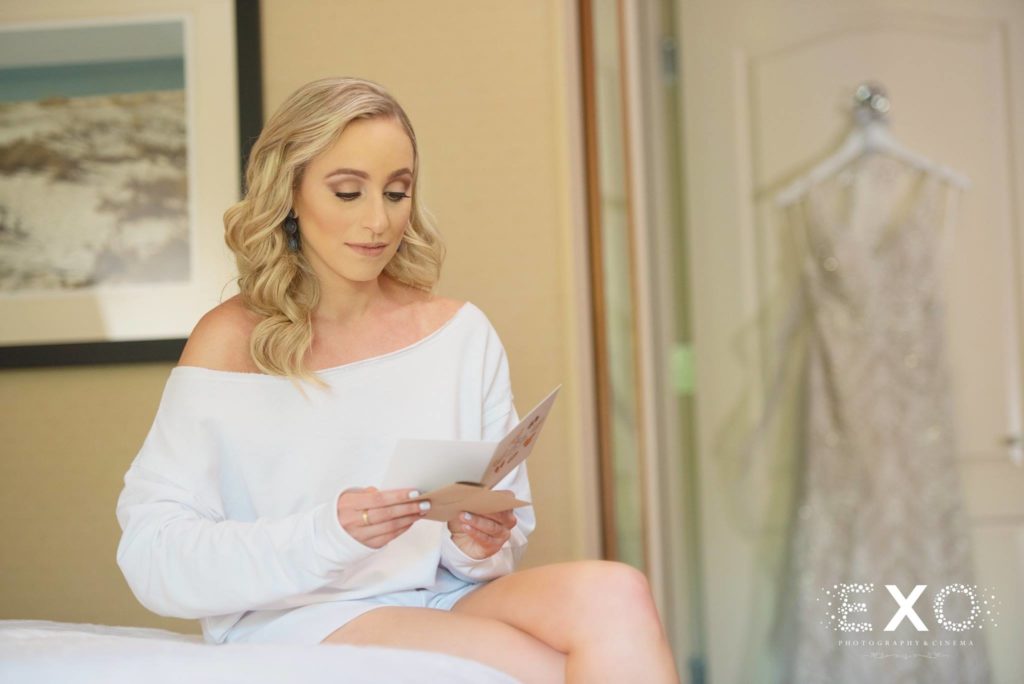 bride reading the note her groom wrote her