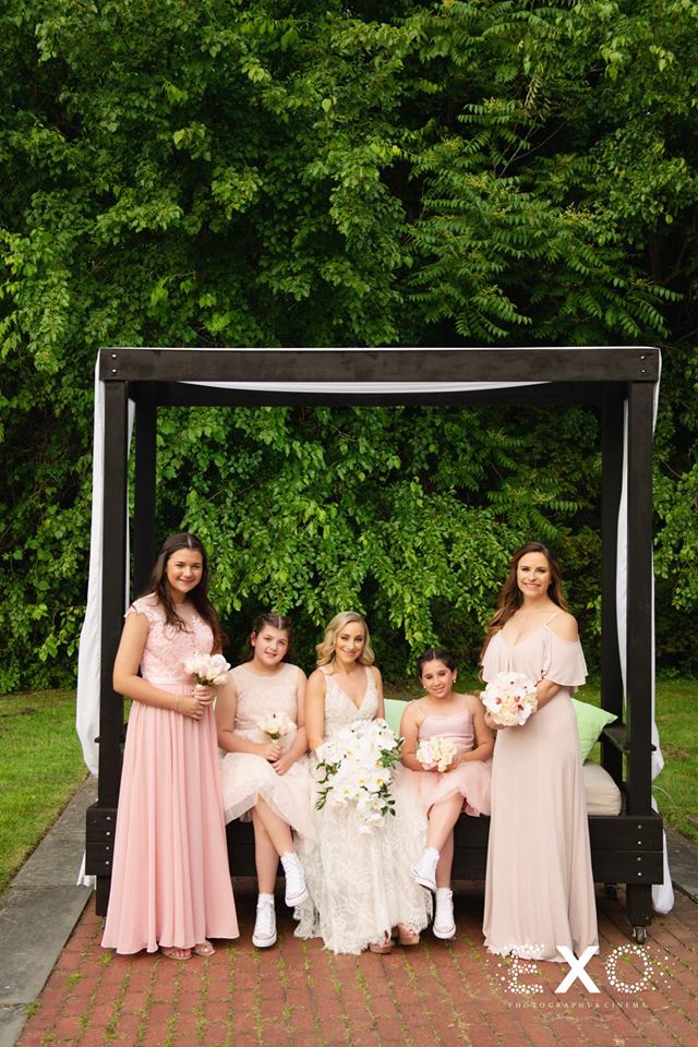 bride and bridesmaids outside Woodbury Country Club