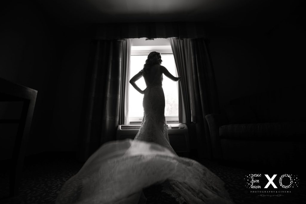 beautiful bride standing in window at Woodbury Country Club