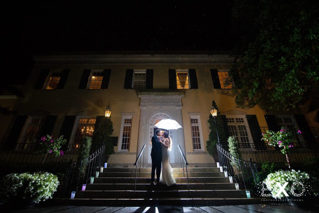 bride and groom kissing in the dark outside The Mansion at Oyster Bay