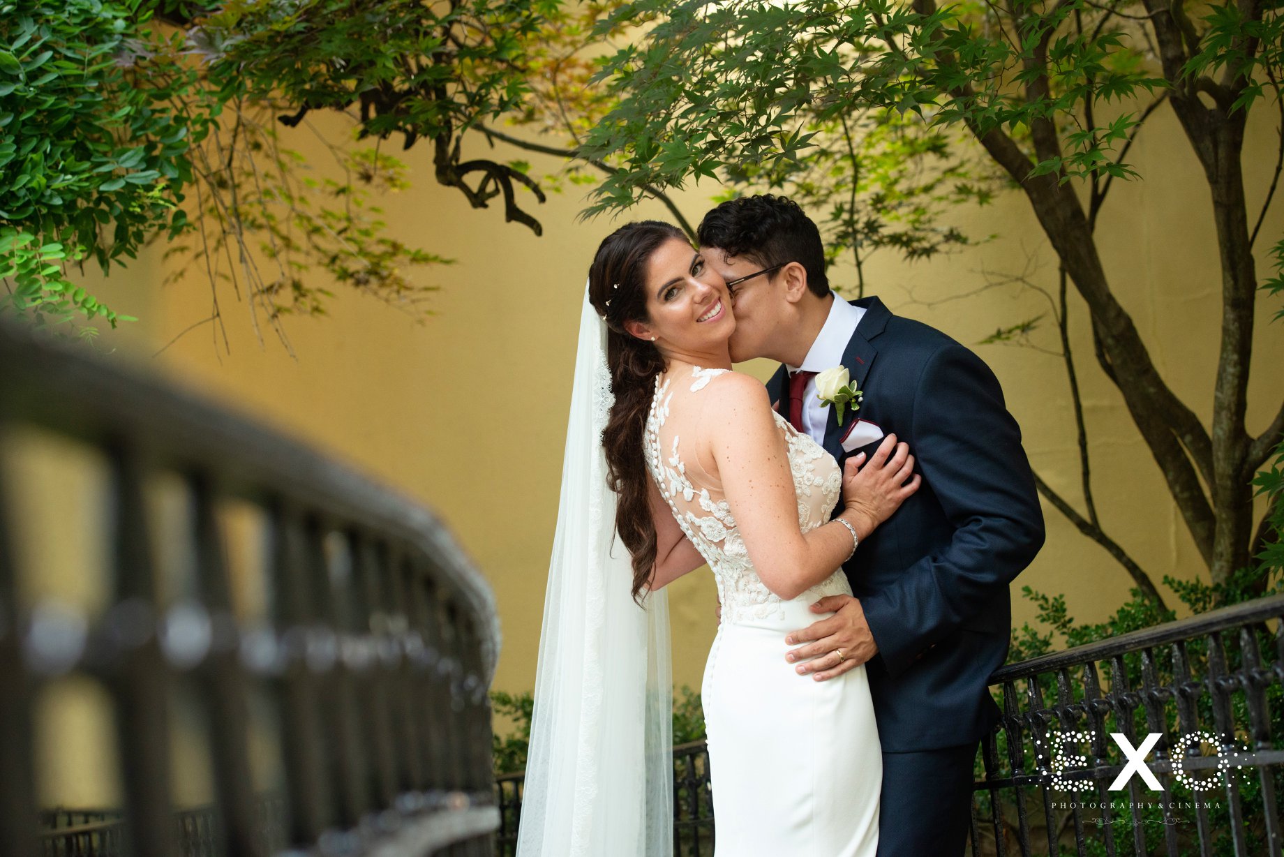 groom kissing the bride at The Mansion at Oyster Bay