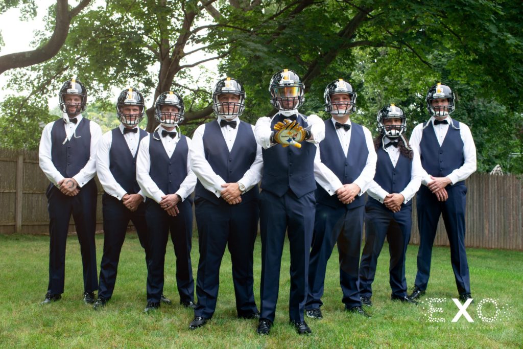 groomsmen with football helmets on