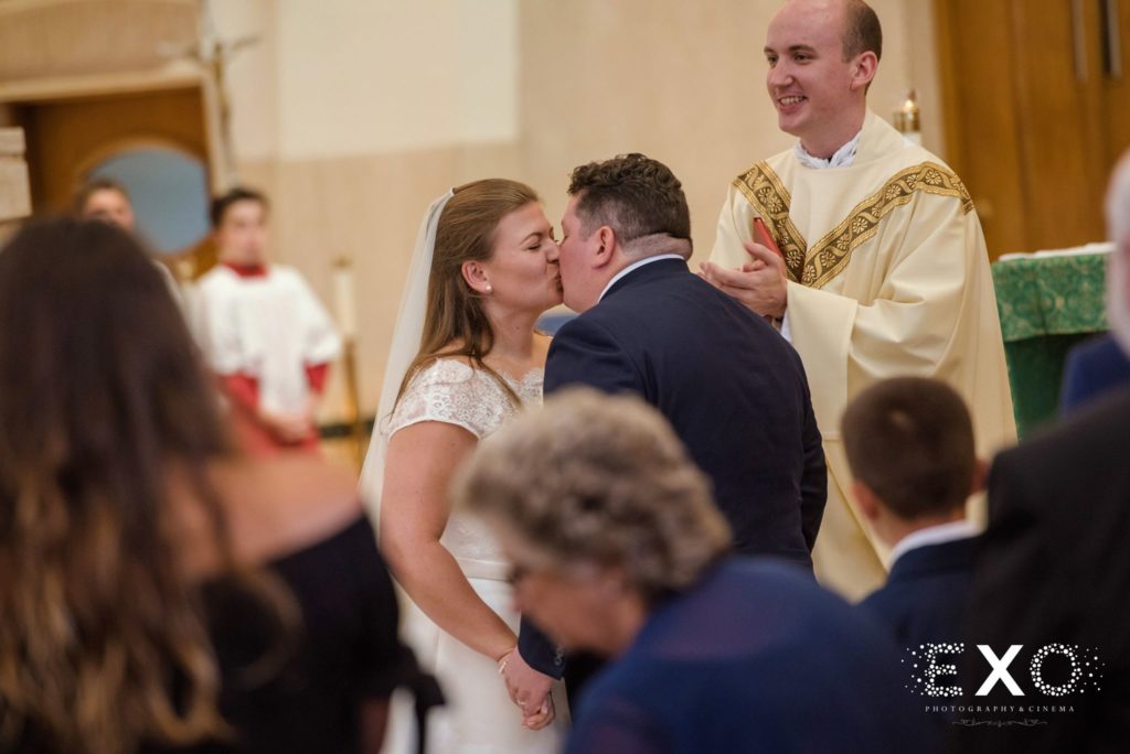 bride and groom kissing as man and wife