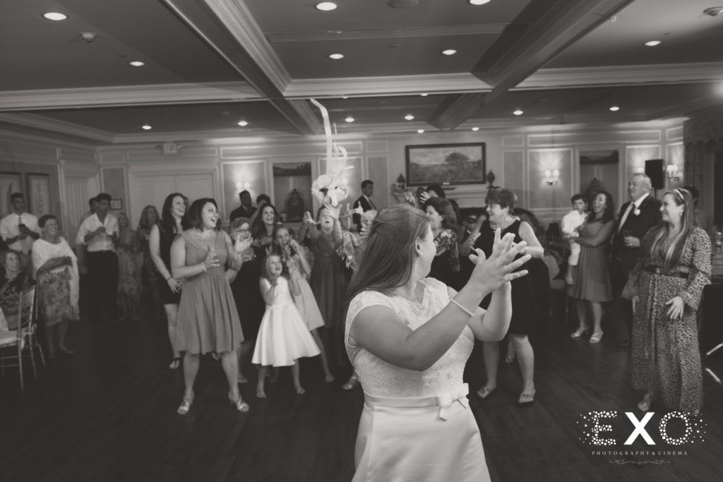 bride throwing her bouquet at Huntington Country Club