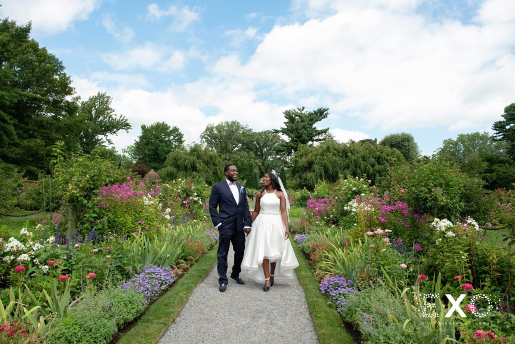 bride and groom walking through Old Westbury Gardens