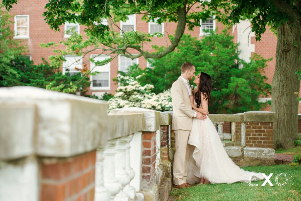 bride and groom kissing outside Bourne Mansion